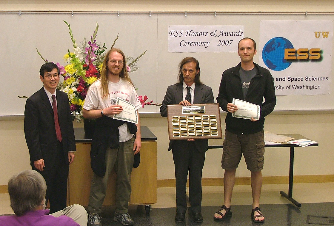 Photo of Brentwood Higman and Michael Kokorowski
	receiving the top graduate student Johnston Prize.